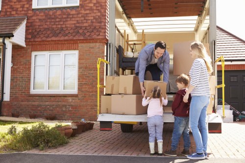 Moving crew handling boxes and furniture during a residential relocation