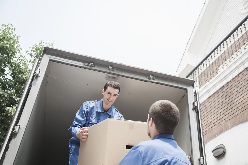 Helper moving belongings from a flat in Stockwell with a van nearby